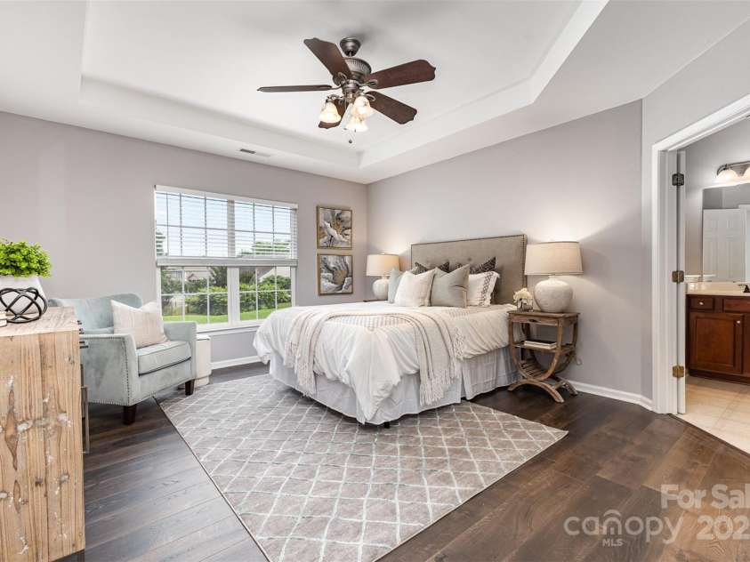 10198 Tintinhull Drive, Indian Land, SC 29707.  MLS# CAR4265539, YatesRealty ID 25357. Gorgeous double door entry 1st floor primary ensuite with Tray Ceiling, LVP flooring, Ceiling Fan and walk-in closet that looks out to your Backyard.