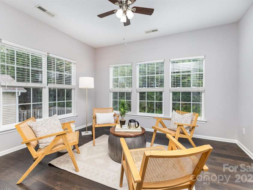 10198 Tintinhull Drive, Indian Land, SC 29707.  MLS# CAR4265539, YatesRealty ID 25357. Sunroom just off your breakfast area with newer LVP flooring installed in 2021,  leading out to your back newly stained deck.