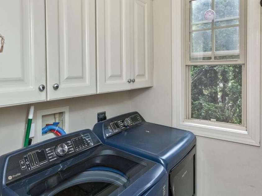 33 Stone House Road, Arden, NC 28704.  MLS# CAR4261250, YatesRealty ID 25362. Laundry room off kitchen and garage. Cabinet builtins