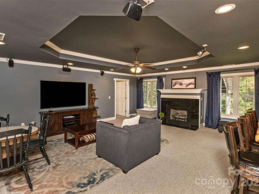 33 Stone House Road, Arden, NC 28704.  MLS# CAR4261250, YatesRealty ID 25362. Tray ceiling in the basement along with windows.  Easy access to the back patio and private yard.