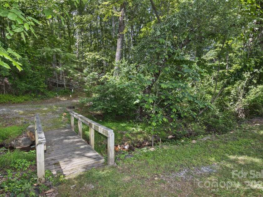 33 Stone House Road, Arden, NC 28704.  MLS# CAR4261250, YatesRealty ID 25362. Wooden bridge accessing the community walking trails