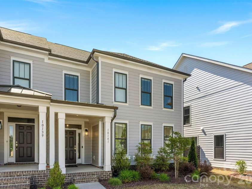 10141 Rainier Trail Drive, Huntersville, NC 28078.  MLS# CAR4375749, YatesRealty ID 25370. Exterior features include durable Hardie Plank siding, complemented by the aesthetic appeal of beautiful, black-paned windows, enhanced further with charming window boxes.