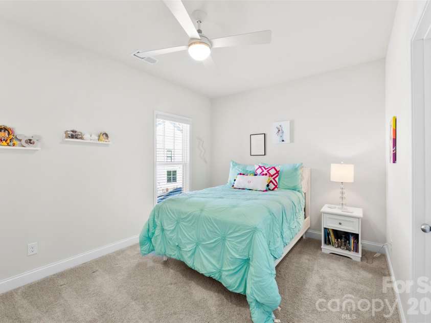 10141 Rainier Trail Drive, Huntersville, NC 28078.  MLS# CAR4375749, YatesRealty ID 25370. Spacious third bedroom with upgraded ceiling fan for enhanced comfort and the inclusion of a spacious walk-in closet, providing excellent storage solutions and organizational opportunities.