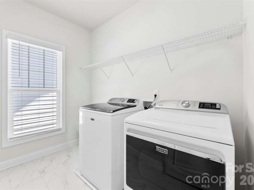 10141 Rainier Trail Drive, Huntersville, NC 28078.  MLS# CAR4375749, YatesRealty ID 25370. The property features a spacious and conveniently located laundry room, easily accessible on the second floor, offering added comfort and functionality for daily home management.