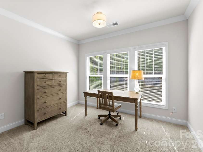 10141 Rainier Trail Drive, Huntersville, NC 28078.  MLS# CAR4375749, YatesRealty ID 25370. The sitting area located within the primary suite, envisioning its transformation into a haven of relaxation and rejuvenation. The goal is to create a tranquil escape from the everyday pressures, fostering a s