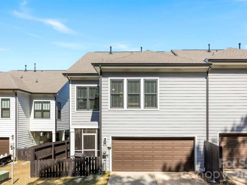 10141 Rainier Trail Drive, Huntersville, NC 28078.  MLS# CAR4375749, YatesRealty ID 25370. The spacious two-car garage is thoughtfully positioned at the rear of the property, providing an excellent level of privacy and enhancing the overall security of the home and its occupants.