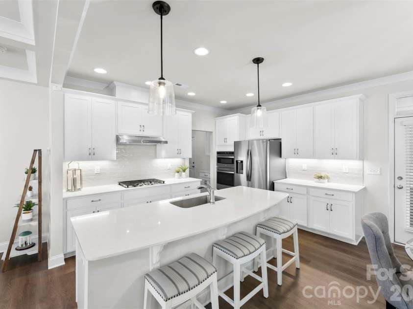 10141 Rainier Trail Drive, Huntersville, NC 28078.  MLS# CAR4375749, YatesRealty ID 25370. This property boasts an impressive array of upgrades throughout, creating a truly exceptional living space. The kitchen is a highlight, featuring stunning quartz countertops complemented by a beautiful tile ba