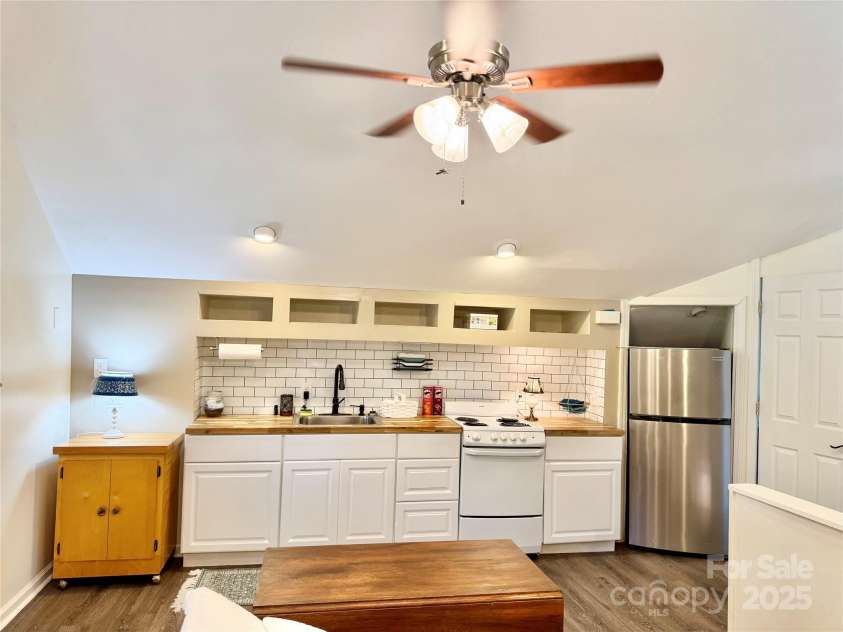 227 Reep Drive, Morganton, NC 28655.  MLS# CAR4312133, YatesRealty ID 25372. Apartment kitchen with butcher block countertops and a stainless refrigerator that stays.