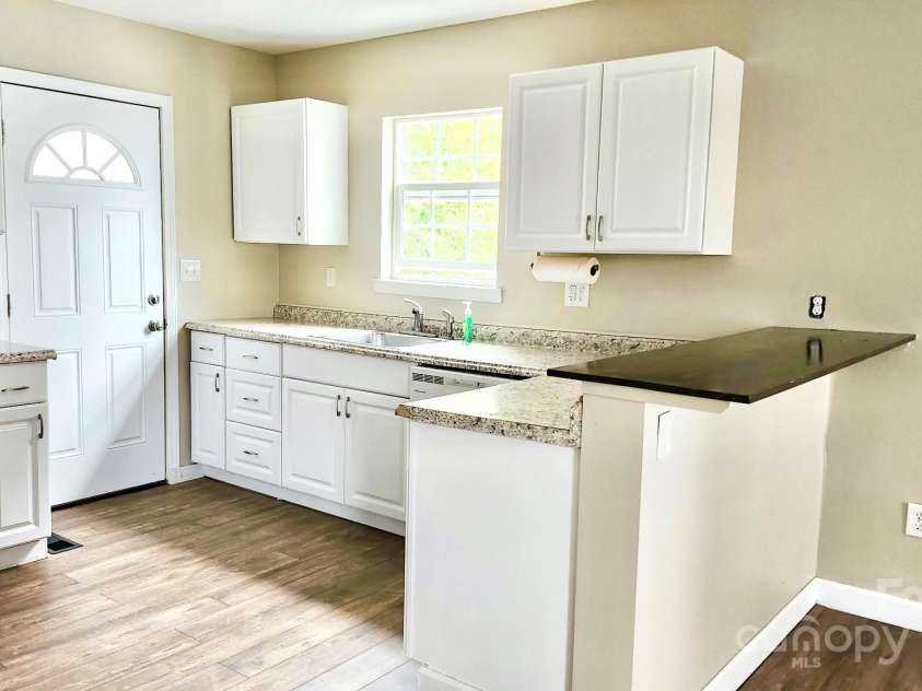 227 Reep Drive, Morganton, NC 28655.  MLS# CAR4312133, YatesRealty ID 25372. Cottage kitchen. All appliances including the refrigerator and washer/dryer to stay.