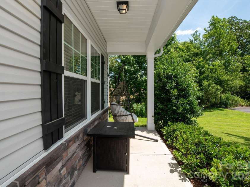 389 Whispering Hills Drive, Locust, NC 28097.  MLS# CAR4273635, YatesRealty ID 25374. Southern front porch