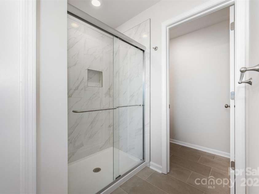 3001 Sadler Woods Lane, Charlotte, NC 28214.  MLS# CAR4272760, YatesRealty ID 25380. Tile shower & floor. Representational Photo.