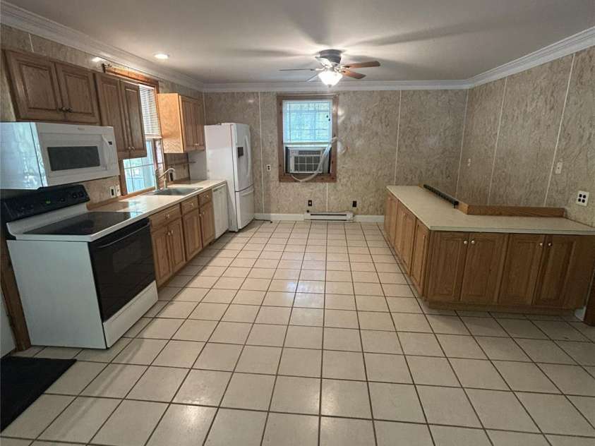 2051 Sutton Spring Road, York, SC 29745.  MLS# CAR4383938, YatesRealty ID 25388. Full kitchen with stairs behind cabinets