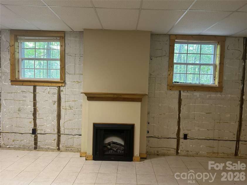2051 Sutton Spring Road, York, SC 29745.  MLS# CAR4383938, YatesRealty ID 25388. Unfinished basement with electric fireplace