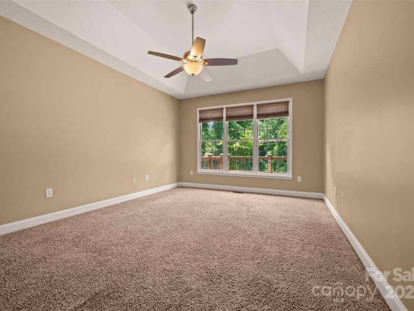 60 Bridge Lane, Tryon, NC 28782.  MLS# CAR4280439, YatesRealty ID 25389. Primary Bedroom with a Tray Ceiling