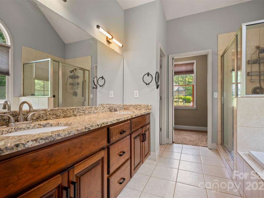60 Bridge Lane, Tryon, NC 28782.  MLS# CAR4280439, YatesRealty ID 25389. Primary Ensuite Bath with tile flooring and granite countertops