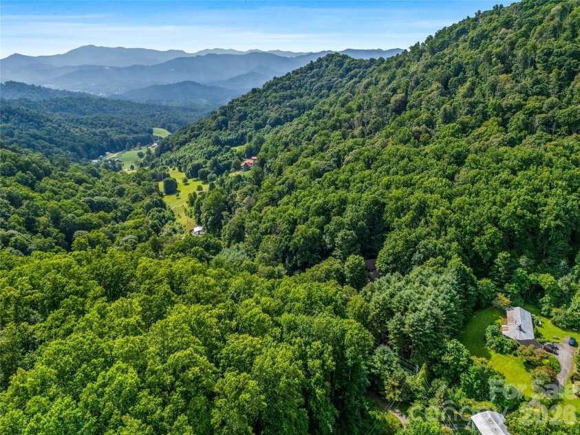 81 Summer Trees Lane, Burnsville, NC 28714.  MLS# CAR4417537, YatesRealty ID 25389. Beautiful long-range Blue Ridge Mountain views framed by lush, forested ridgelines.