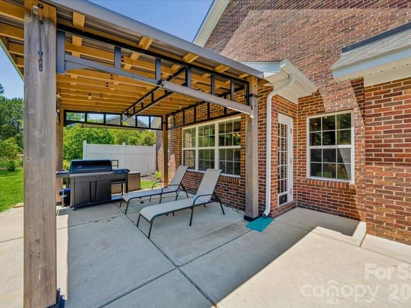 1006 Spring Rose Lane, Matthews, NC 28104.  MLS# CAR4382311, YatesRealty ID 25396. Back Patio Pergola