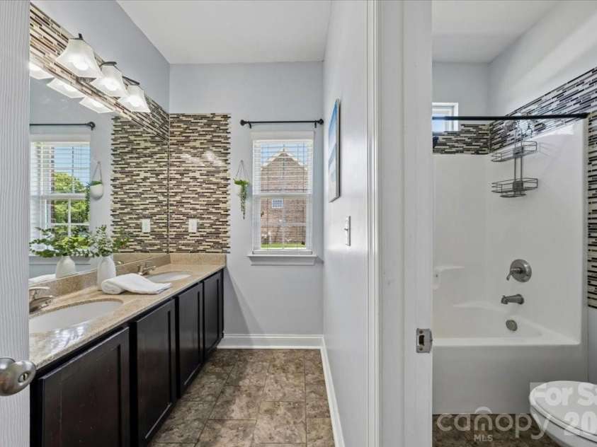 1006 Spring Rose Lane, Matthews, NC 28104.  MLS# CAR4382311, YatesRealty ID 25396. Second Bathroom