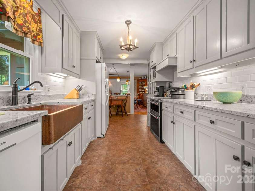 85 Red Bird Road, Tryon, NC 28782.  MLS# CAR4278468, YatesRealty ID 25406. Kitchen to Dining Room