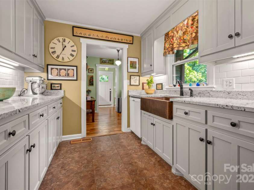 85 Red Bird Road, Tryon, NC 28782.  MLS# CAR4278468, YatesRealty ID 25406. Kitchen to Laundry and En Suite Bedroom