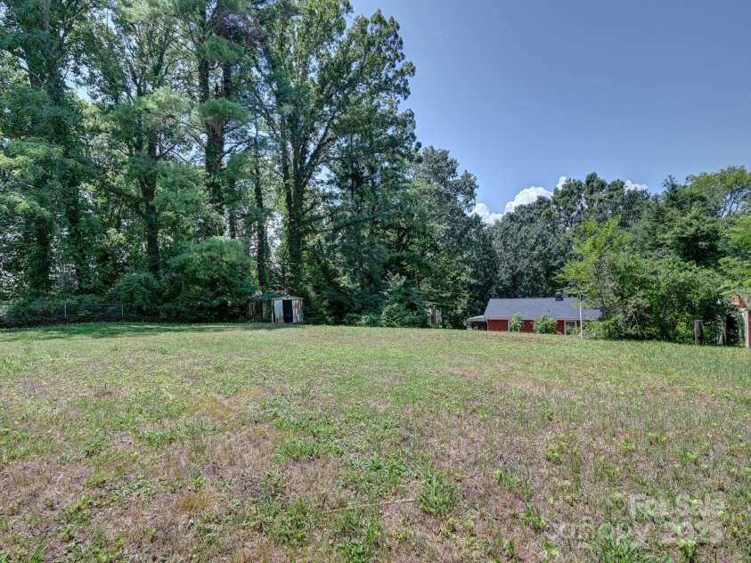 123 Blake Drive, Arden, NC 28704.  MLS# CAR4276075, YatesRealty ID 25432. Level area is RR Easement-Makes back area seem even larger!