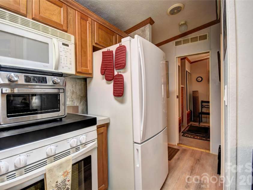 279 Mallard Loop, Waynesville, NC 28785.  MLS# CAR4380212, YatesRealty ID 25434. Refrigerator as you start down the hall
