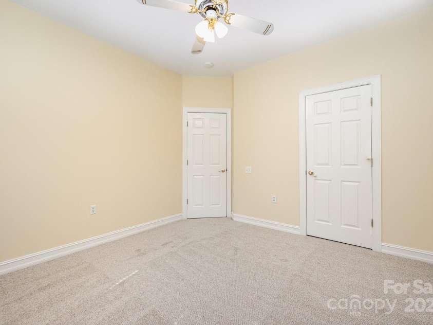 975 Pine Knoll Road, Fort Mill, SC 29715.  MLS# CAR4274032, YatesRealty ID 25440. Bedroom #2 features new carpet, new paint, a ceiling fan and closet