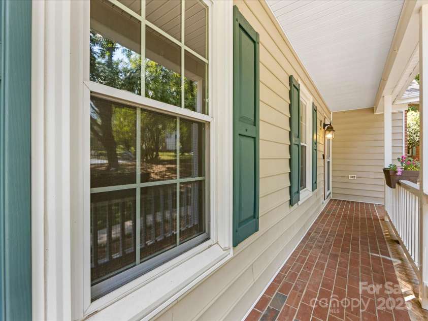 4601 Bournewood Lane, Charlotte, NC 28226.  MLS# CAR4278475, YatesRealty ID 25454. An adorable covered front porch welcomes guests to the home and is a fun spot to enjoy morning coffee!