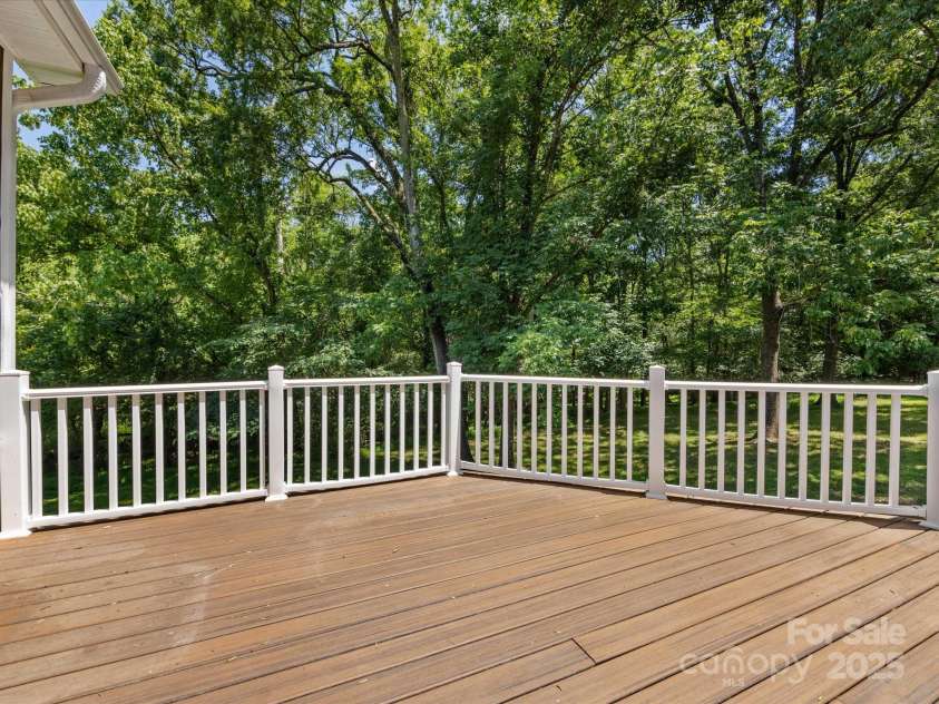 4601 Bournewood Lane, Charlotte, NC 28226.  MLS# CAR4278475, YatesRealty ID 25454. Look at this Trex deck overlooking the gorgeous tree-lined yard!