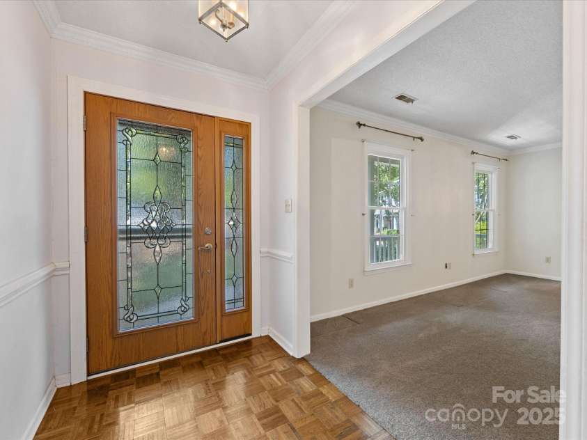 4601 Bournewood Lane, Charlotte, NC 28226.  MLS# CAR4278475, YatesRealty ID 25454. The welcoming foyer opens to the living and dining rooms.