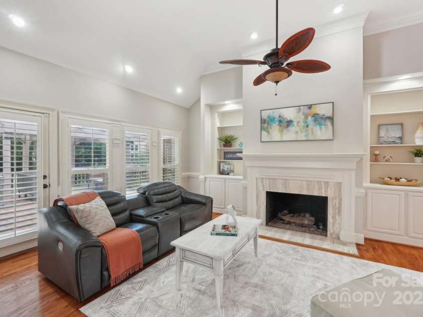 7626 Vistaview Drive, Cornelius, NC 28031.  MLS# CAR4247713, YatesRealty ID 25457. Family room w/built-in shelving, recessed lighting, gas fireplace & mantel