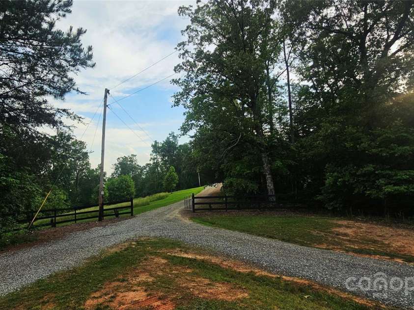 1171 Clark Road, Rutherfordton, NC 28139.  MLS# CAR4263600, YatesRealty ID 25465. Leaving driveway and views with open pasture for animals or gardening, whatever you desire!