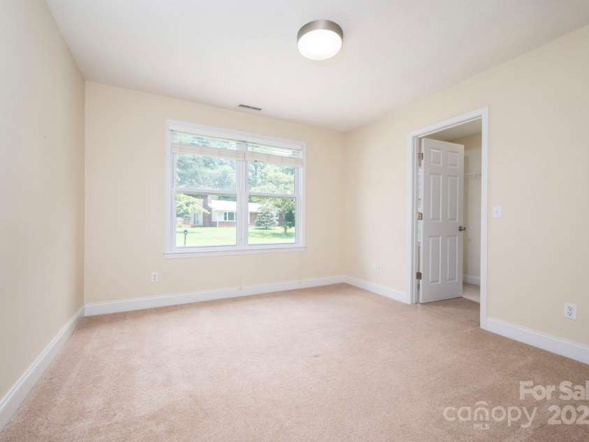 29 Honey Hollow Lane, Fairview, NC 28730.  MLS# CAR4270487, YatesRealty ID 25480. Front bedroom with walk-in closet