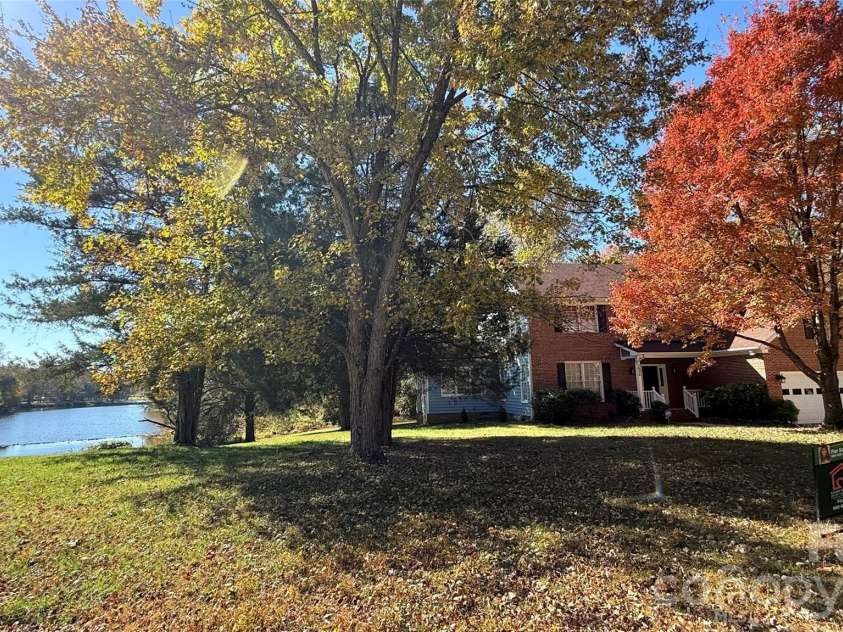 2836 Pickering Road, Greensboro, NC 27407.  MLS# CAR4275274, YatesRealty ID 25483. Main photo of house and lake
