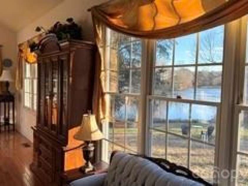 2836 Pickering Road, Greensboro, NC 27407.  MLS# CAR4275274, YatesRealty ID 25483. Spacious dining room showcasing serene backyard lake views 