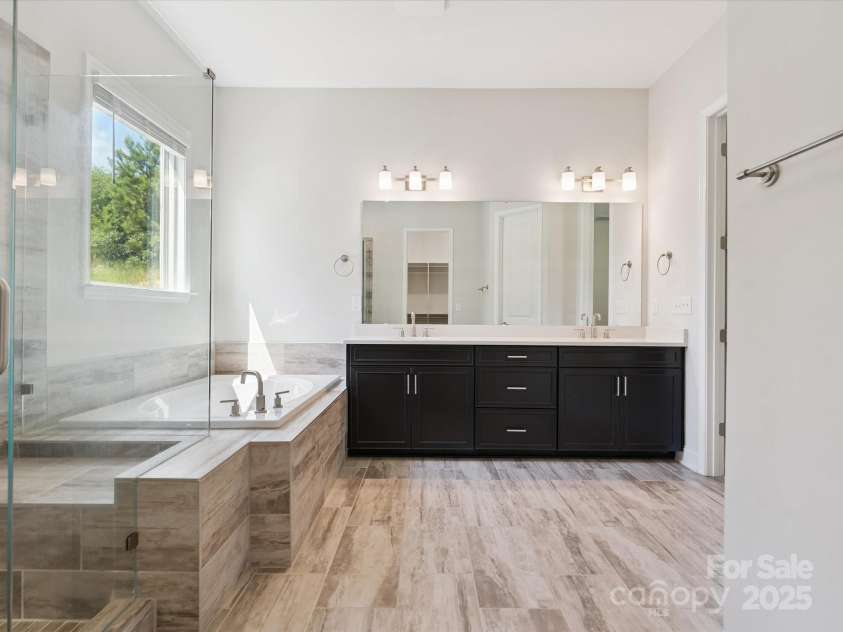 2270 Excalibur Drive, Indian Land, SC 29707.  MLS# CAR4279669, YatesRealty ID 25486. Gorgeous spa like bathroom with seamless shower, dual sinks neutral tile