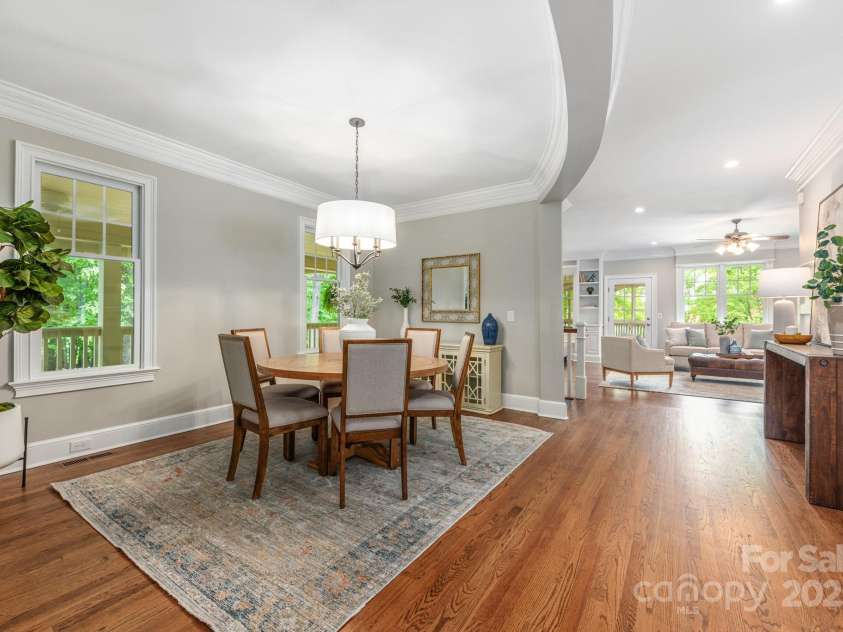 3201 Oak Brook Drive, Waxhaw, NC 28173.  MLS# CAR4247605, YatesRealty ID 25490. Open Dining Room with views of the wrap around porch and wooded side yard