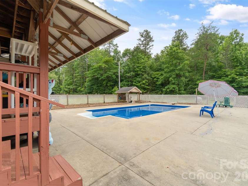 229 Oakridge Road, Stanley, NC 28164.  MLS# CAR4386671, YatesRealty ID 25518. Pool and covered back porch
