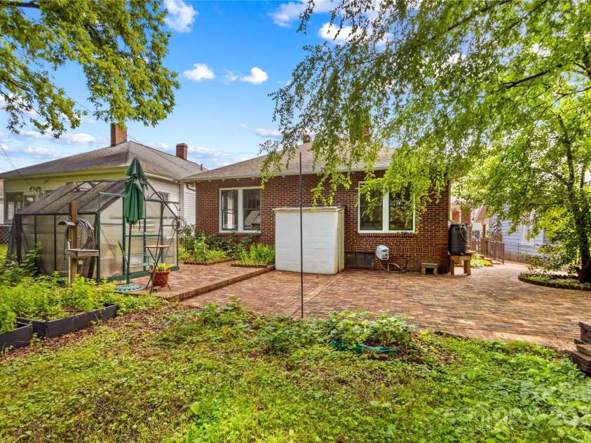 119 Wiley Avenue, Salisbury, NC 28144.  MLS# CAR4250756, YatesRealty ID 25522. Back patio greenhouse and raised beds