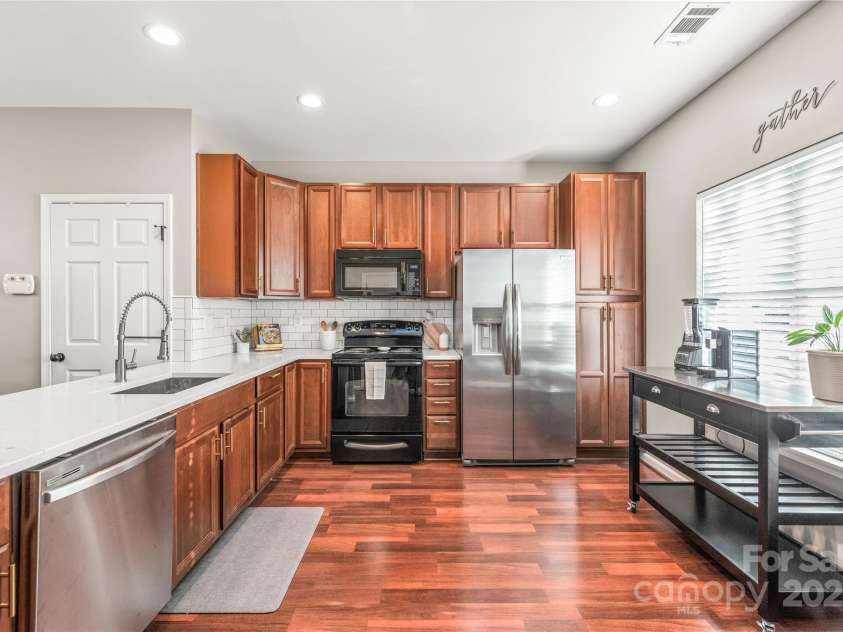 114 Clydesdale Court, Matthews, NC 28104.  MLS# CAR4234456, YatesRealty ID 2555. Create culinary masterpieces in this stunning kitchen with beautiful wood cabinets, white countertops, tile back splash and ample space perfect for cooking and entertaining!