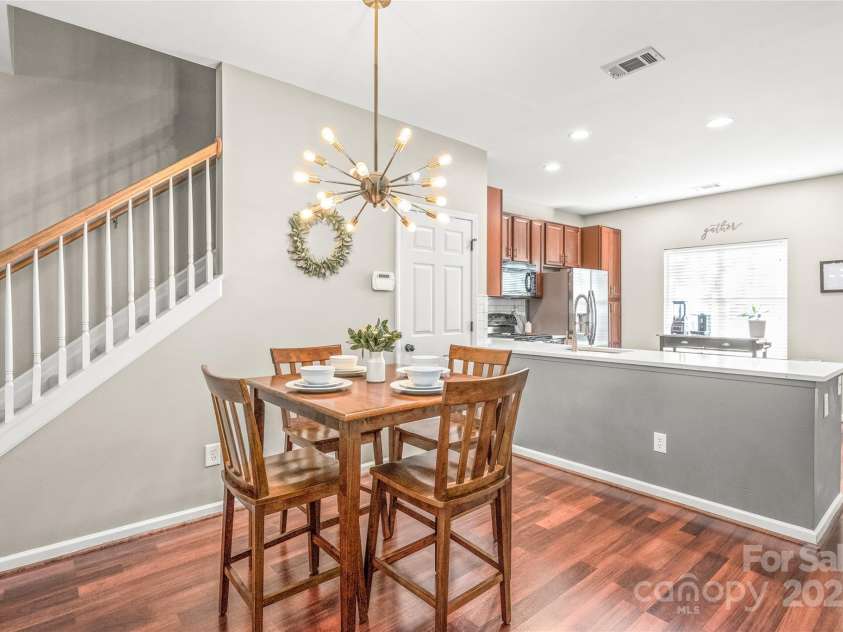114 Clydesdale Court, Matthews, NC 28104.  MLS# CAR4234456, YatesRealty ID 2555. Start your mornings in style in the charming breakfast area, featuring designer lighting that adds a touch of elegance.