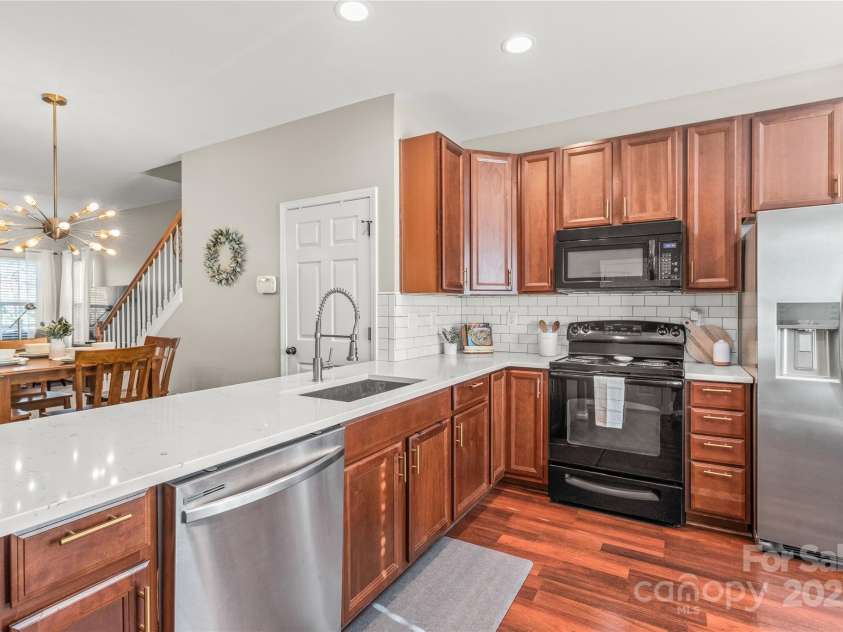 114 Clydesdale Court, Matthews, NC 28104.  MLS# CAR4234456, YatesRealty ID 2555. The open-concept kitchen seamlessly flows into the dining room, making entertaining and family meals a breeze!