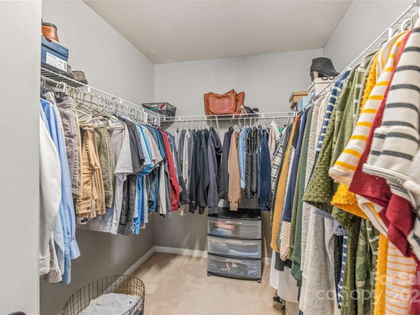 114 Clydesdale Court, Matthews, NC 28104.  MLS# CAR4234456, YatesRealty ID 2555. The primary bedroom features a spacious walk-in closet, providing plenty of room to keep your wardrobe organized.