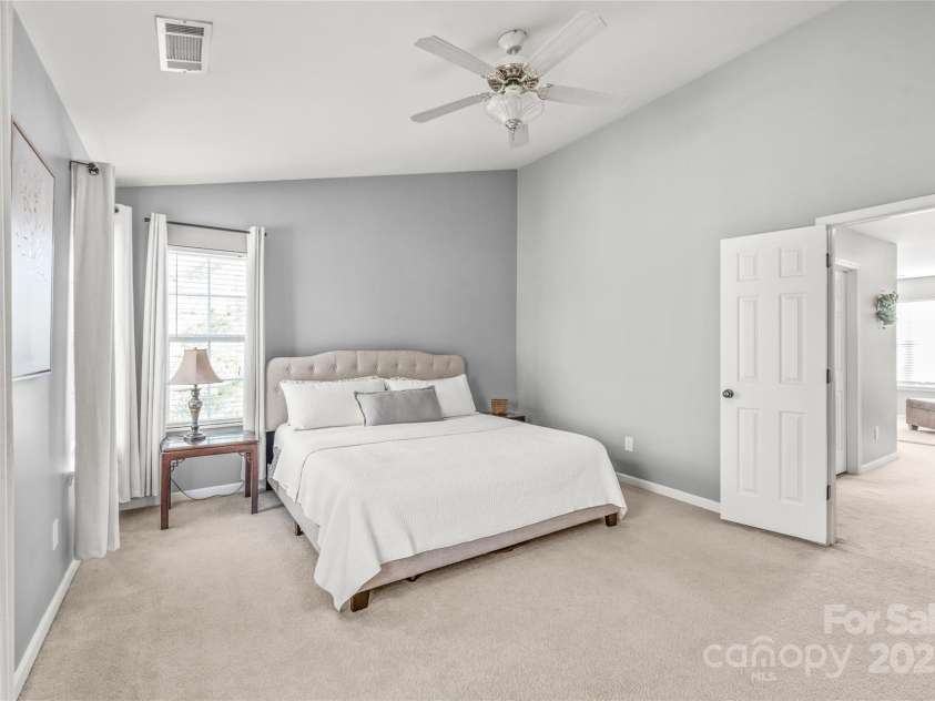 114 Clydesdale Court, Matthews, NC 28104.  MLS# CAR4234456, YatesRealty ID 2555. Your perfect retreat awaits in this large primary bedroom, offering ample space and a serene atmosphere for relaxation and comfort.