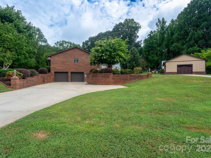 614 Azalea Lane, China Grove, NC 28023.  MLS# CAR4280599, YatesRealty ID 25550. Driveway to the side entrance for the basement. Detached garage has separate driveway.