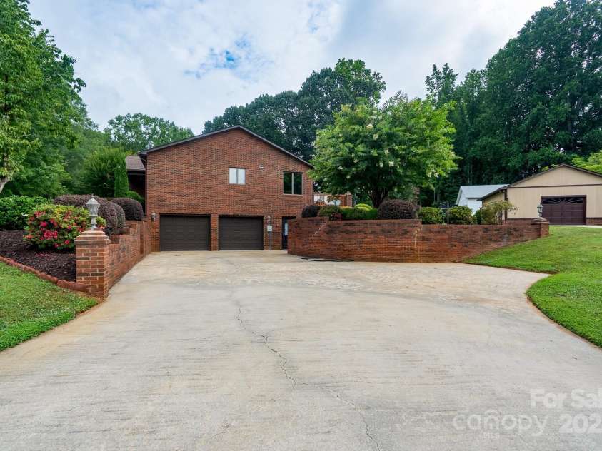614 Azalea Lane, China Grove, NC 28023.  MLS# CAR4280599, YatesRealty ID 25550. Driveway view to the garage and side entrance to the basement.