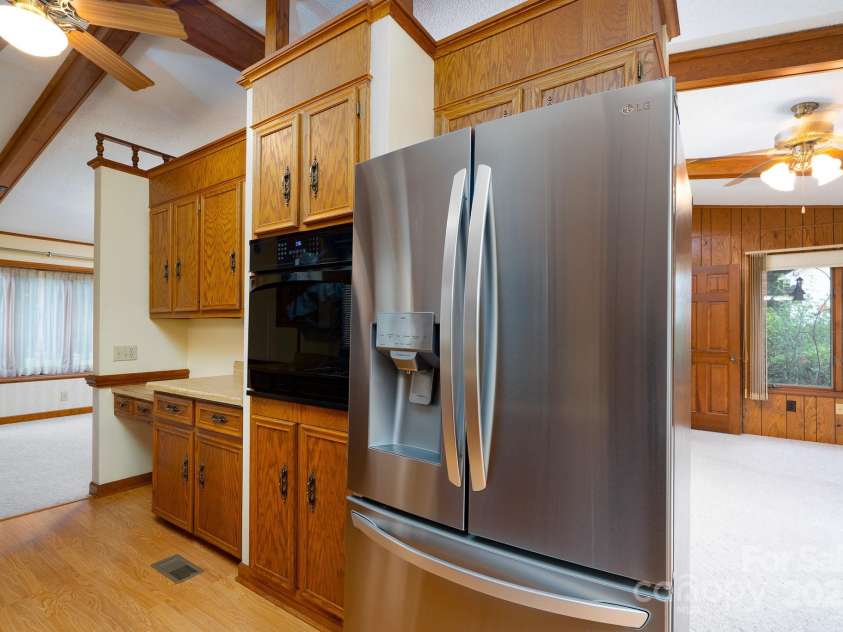 614 Azalea Lane, China Grove, NC 28023.  MLS# CAR4280599, YatesRealty ID 25550. Kitchen with computed niche. Electric oven to the left of the refrigerator.