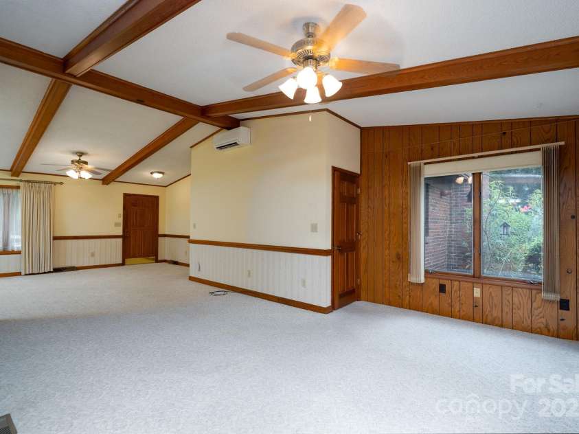 614 Azalea Lane, China Grove, NC 28023.  MLS# CAR4280599, YatesRealty ID 25550. Living room looking at basement door on right and front door to the left. Ceiling accents.