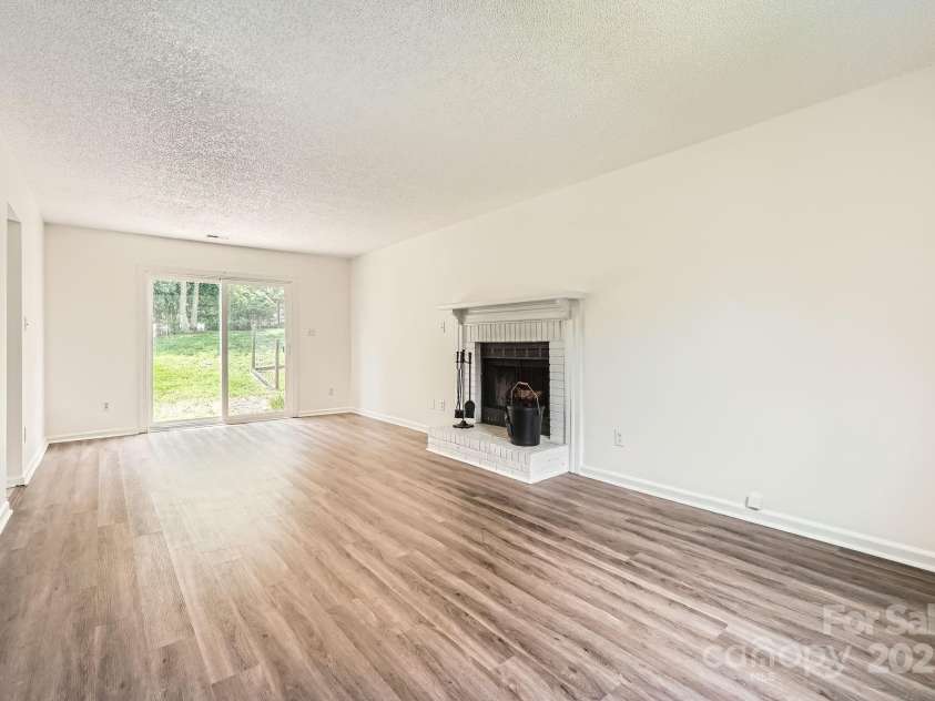 6221 Round Hill Road, Charlotte, NC 28211.  MLS# CAR4264179, YatesRealty ID 25553. Family room with wood burning fireplace!