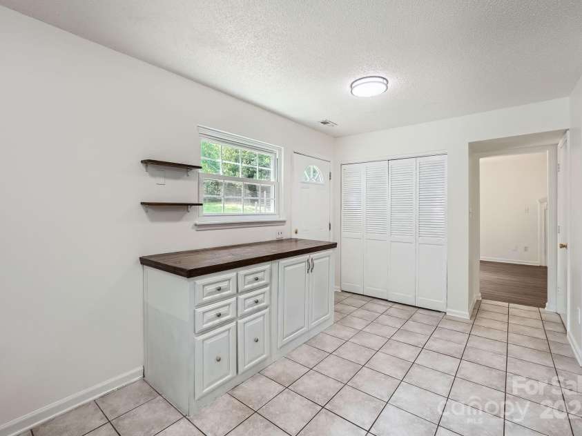 6221 Round Hill Road, Charlotte, NC 28211.  MLS# CAR4264179, YatesRealty ID 25553. Perfectly placed storage with wood countertop overlooking the backyard!
